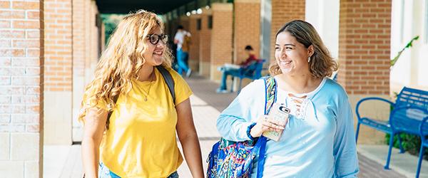 two female students walking on St. Philip's campus